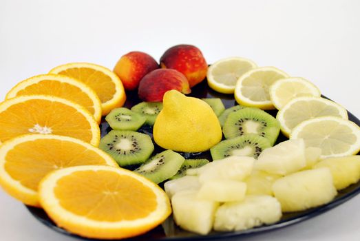Fresh different fruit on black dish