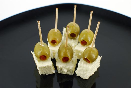 Olives and feta cheese on black dish