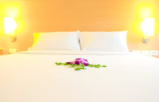 Interior of modern bedroom (selective focus on orchid flowers decoration)