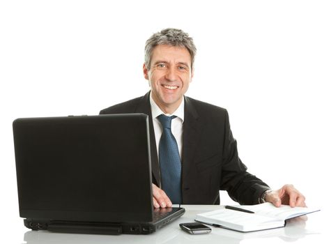 Senior business man working on laptop. Isolated on white