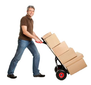 Delivery man with hand truck and stack of boxes. Isolated on white