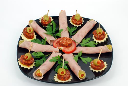 Decorative catering food on black dish