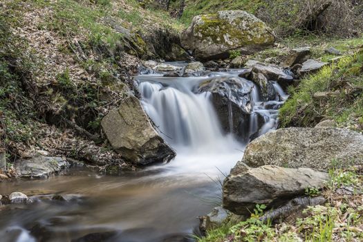 Cascades on a mountain river with a silky effect on the water that conveys a sense of relaxation.