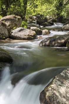 Cascades on a mountain river with a silky effect on the water that conveys a sense of relaxation.