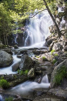 Cascades on a mountain river with a silky effect on the water that conveys a sense of relaxation.