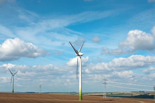 Wind-powered electricity generators at farmer's field.