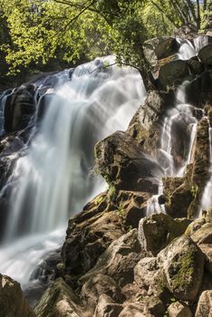 Cascades on a mountain river with a silky effect on the water that conveys a sense of relaxation.