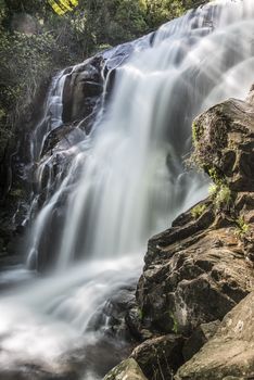 Cascades on a mountain river with a silky effect on the water that conveys a sense of relaxation.