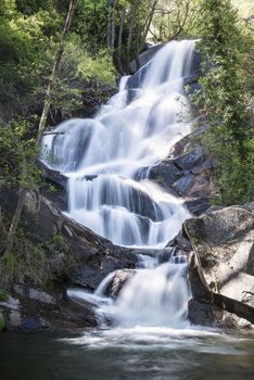 Cascades on a mountain river with a silky effect on the water that conveys a sense of relaxation.