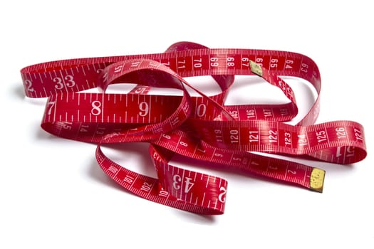 Red tape measure closeup on white background 