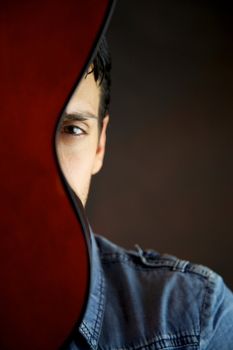 Male model behind guitar portrait