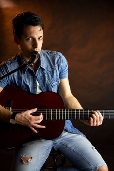 Male model with guitar playing and singing