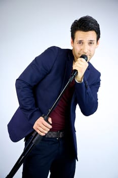 Man singing and posing happy into microphone