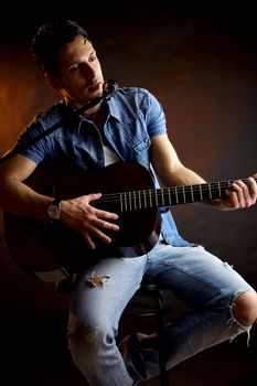 Serious male model with guitar intense