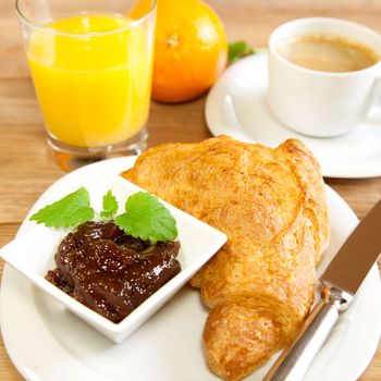 Continental breakfast with croissants and orange juice
