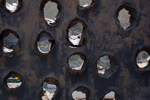 Iron plate with holes from piercing anti armor grenade