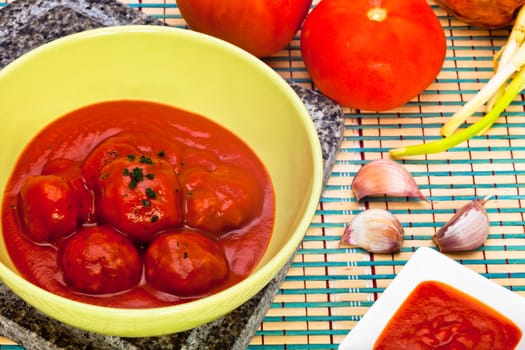 Bowl with meatballs and tomato sauce
