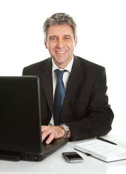 Senior business man working on laptop. Isolated on white