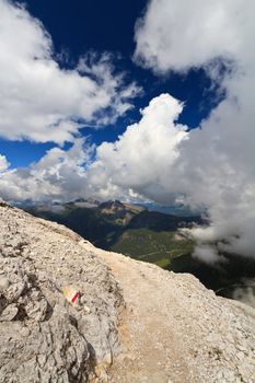 footpath between clouds in Primiero valley, Trentino, Italy