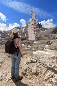 woman facing directions for trekking in Pale di San Martino mount, Italian Dolomites