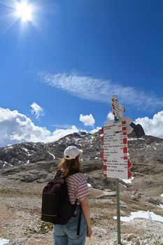 woman facing directions for trekking in Pale di San Martino mount, Italian Dolomites