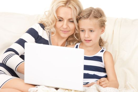 bright picture of happy mother and child with laptop computer