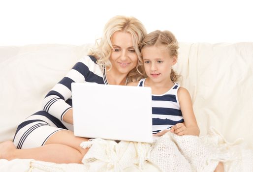 bright picture of happy mother and child with laptop computer