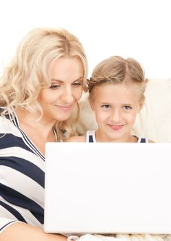 bright picture of happy mother and child with laptop computer