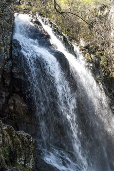 Landscape with vernal waterfall in sunny day