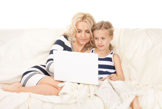 bright picture of happy mother and child with laptop computer