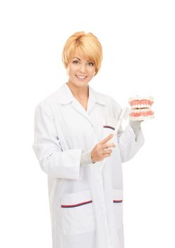 picture of attractive female doctor with toothbrush and jaws