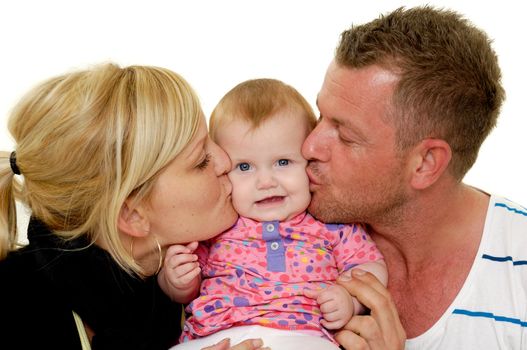 Mother and father are kissing their sweet baby 4 month old baby.