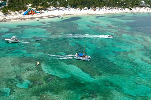 Boats at sea and a exotic beach. Taken form helicopter. The Dominican Republic.