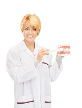 picture of attractive female doctor with toothbrush and jaws