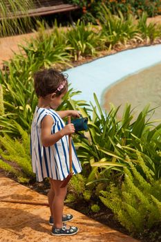 Playing gardening, a small girl having fun