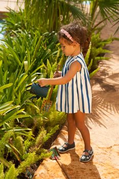 Small girl having fun playing gardening games