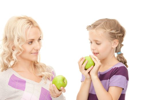 picture of mother and little girl with green apple