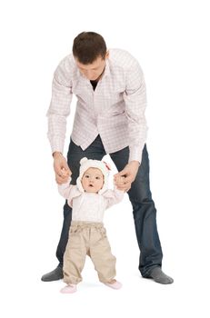 picture of baby making first steps with father help