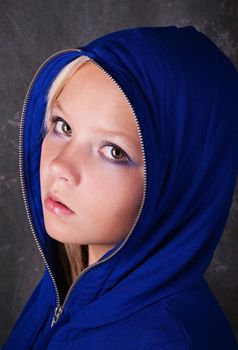 Portrait of young beautiful teen girl in blue hood