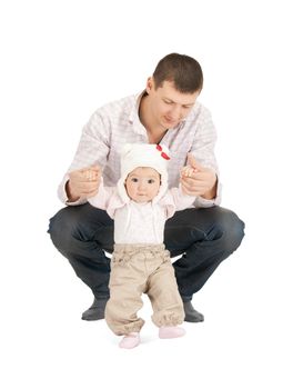 picture of baby making first steps with father help