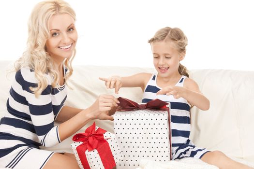 picture of mother and little girl with gifts (focus on daughter).