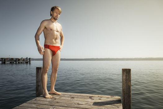 An image of a handsome man at the lake