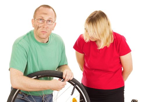 A mechanic repairs the wheel of a bicycle