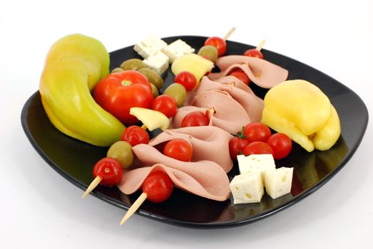 Catering food with salami pepper cheese olives and tomatoes