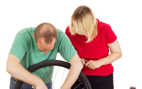 A mechanic repairs the wheel of a bicycle