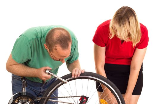 A mechanic repairs the wheel of a bicycle