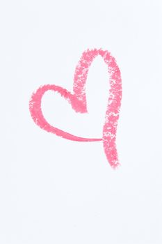 Pink heart drawn on paper with lipstick