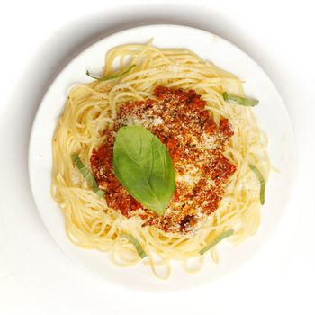 Spaghetti bolognese on white plate top view
