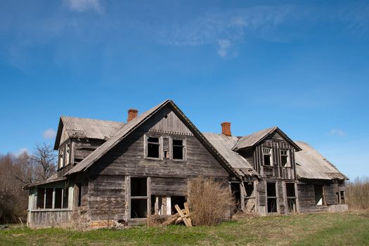 Old wooden abandoned house with broken windows