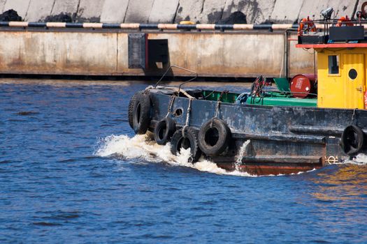 small tugboat float in river with blue water